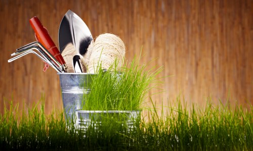 Gardeners removing overgrown shrubs and debris
